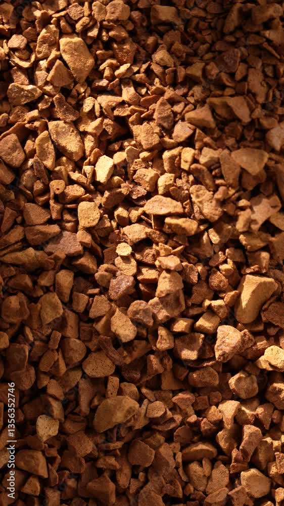 Vertical top-view of a heap of freeze-dried instant coffee, rotating under bright sunlight Vertical top-view of a heap of freeze-dried instant coffee, rotating under bright sunlight