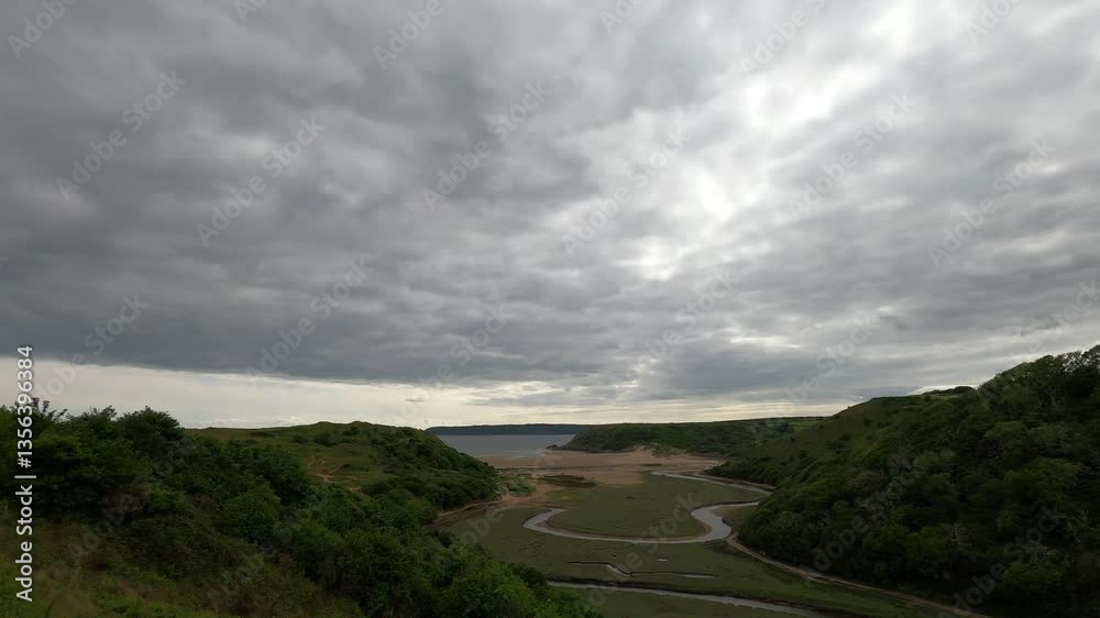 A breathtaking coastal landscape with rolling green hills, a winding river, and a vast sandy beach under a dramatic cloudy sky. A serene and picturesque nature scene perfect for travel. A breathtaking coastal landscape with rolling green hills, a winding river, and a vast sandy beach under a dramatic cloudy sky. A serene and picturesque nature scene perfect for travel.