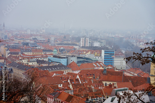 Graz cityscape on foggy day. Panoramic view of Graz, Austria with historical architecture. Streets with red roofed buildings in European city