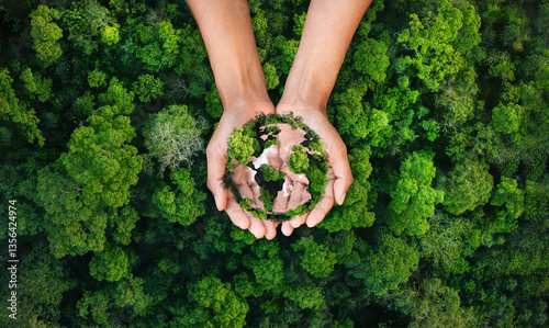 earth day and environment concept globe tree on hand green forest background