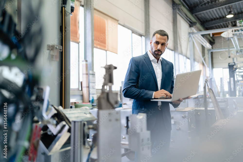 custom made wallpaper toronto digitalBusinessman using laptop in a factory