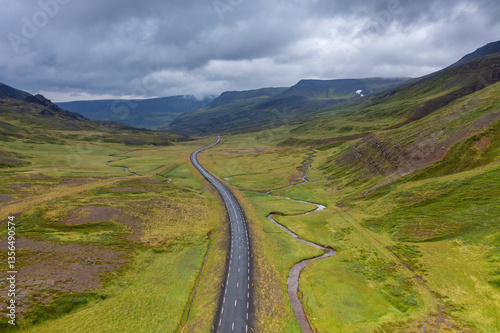 Aerial view of a road through the wilderness in Iceland with a cloudy sky photo