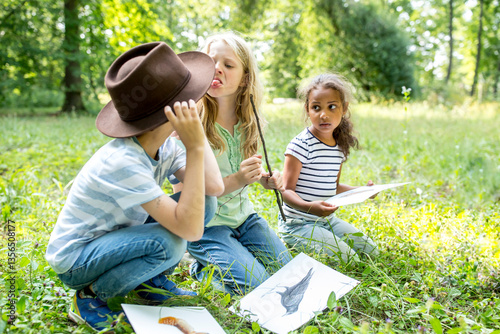 Boy and girl having an argument in nature, girl sticking out tongue