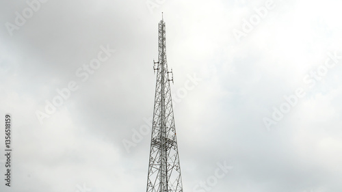 Communication Tower Against Cloudy Sky.