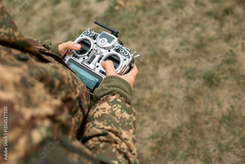 Drone control panel is in hand of military soldier. Artillery spotter or military observer launches drone into sky force reconnaissance in enemy territory.