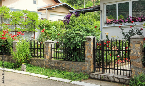 A view on a colorful garden in front of a house.