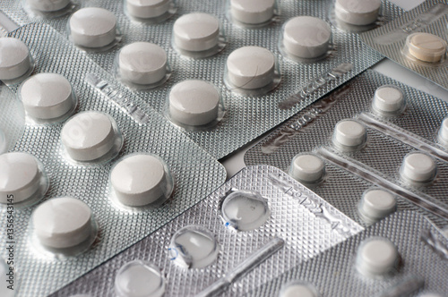 Medical tablets in blisters lie on the surface
