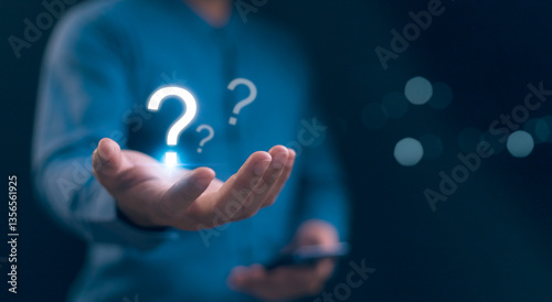 Obraz na płótnie Hands holding FAQ question mark sign. Question Mark and Problem-Solving Concept. Finding answers to business FAQs. Creativity and ideas, asked questions and answers. Brainstorming and problem-solving. w salonie