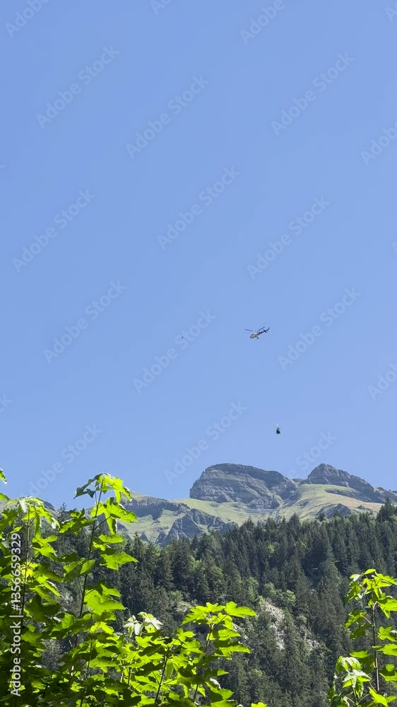 A Stunning Mountain Landscape Featuring a Plane Gracefully Gliding in the Bright Blue Sky Above A Stunning Mountain Landscape Featuring a Plane Gracefully Gliding in the Bright Blue Sky Above