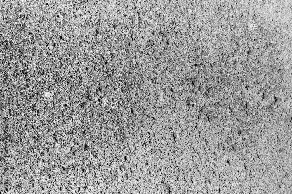 Close view of a weathered concrete surface displaying various textures and patterns formed by erosion. Close view of a weathered concrete surface displaying various textures and patterns formed by erosion.