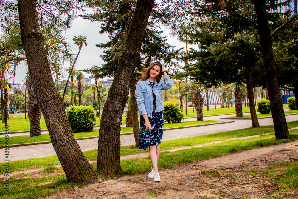 Young woman in a park. Bright green park. 