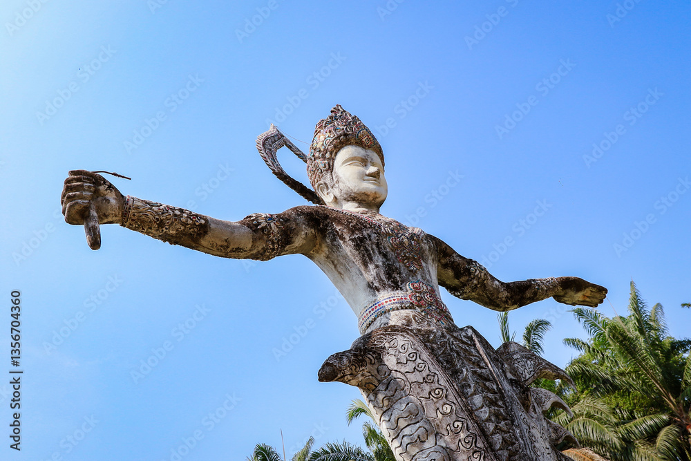 Visit Buddha Park featuring unique sculptures in Vientiane Laos under bright blue sky