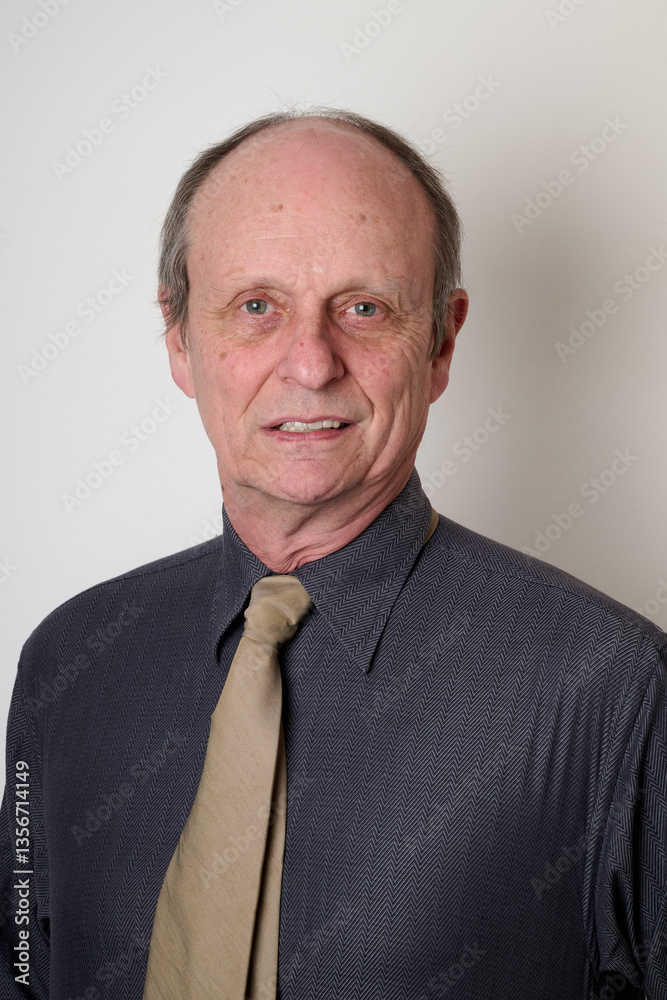 Senior man with a cotton shirt against white wall