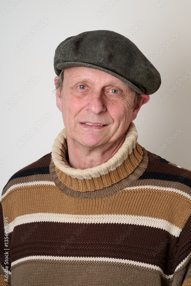 Senior man with a beige turtleneck puulover and a vintage cap