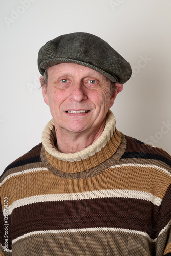 Obraz na płótnie Senior man with a beige turtleneck puulover and a vintage cap w salonie