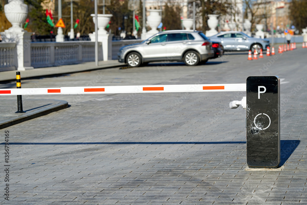 Modern parking barrier with visible impact damage and shattered glass, restricted vehicle entry point, vandalism. Damaged security barrier at lot entrance, accident impact or deliberate destruction