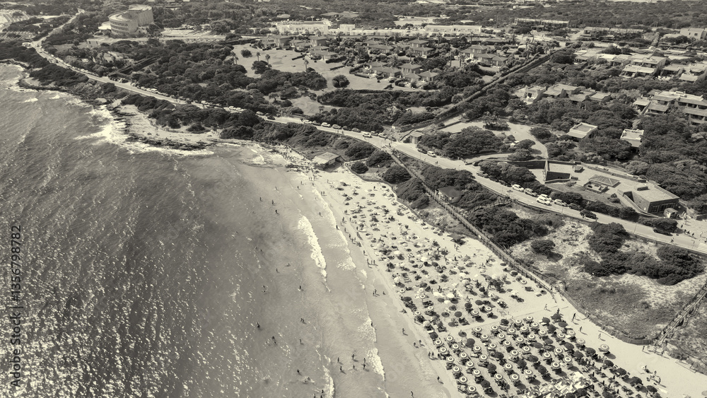 Aerial perspective of Sardinia's Torre della Pelosa and crystal-clear waters of La Pelosa Beach