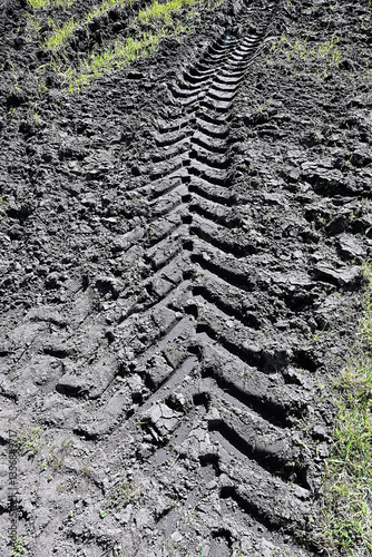 Obraz na płótnie truck tire track in the mud of a cultivated field w salonie
