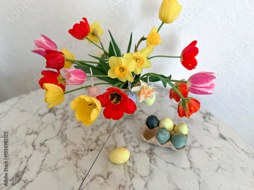 Obraz na płótnie An Easter card. Colorful bright tulips decorated with eggs stand in a vase on the table next to colorful eggs w salonie