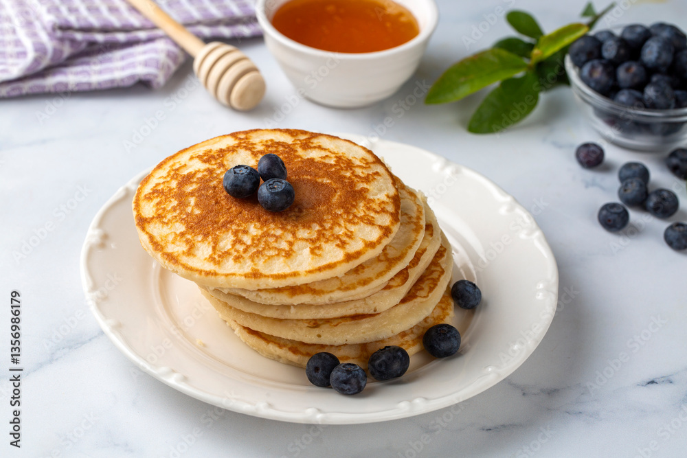 Healthy summer breakfast, homemade classic american pancakes with fresh fruit and honey
