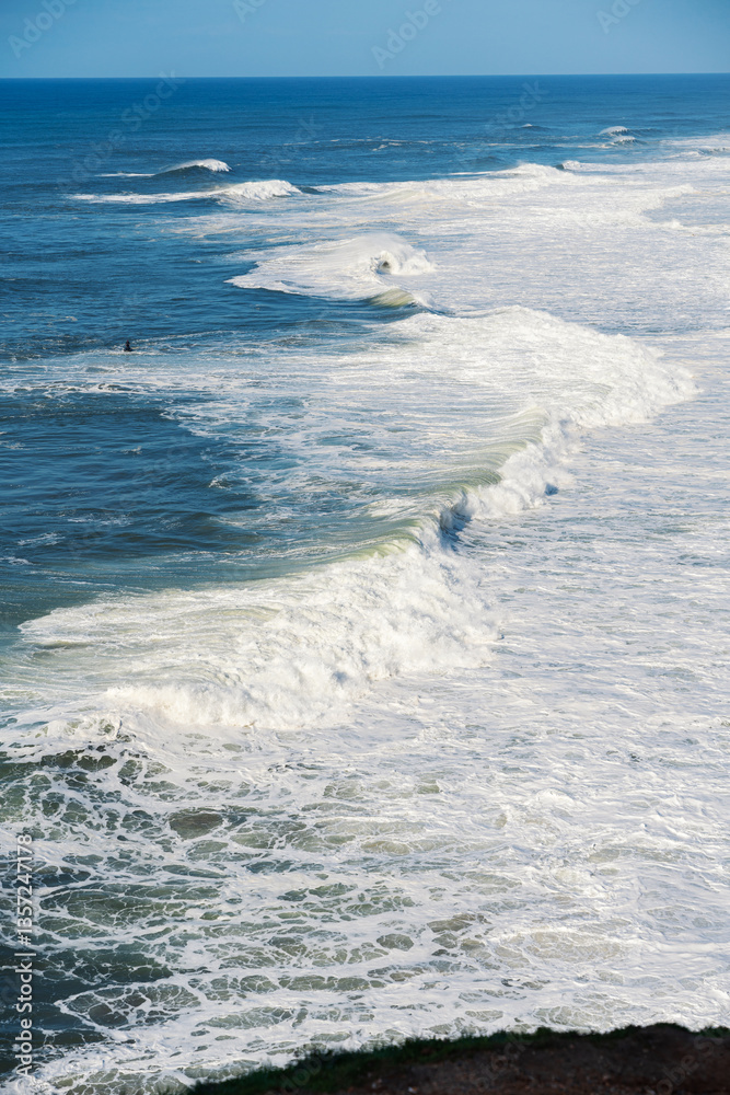 Obraz premium View of jet ski cruising in high speed in Atlantic ocean. Nazare, Portugal