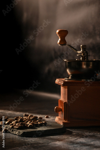 coffee beans scattered on the table. manual coffee grinder
