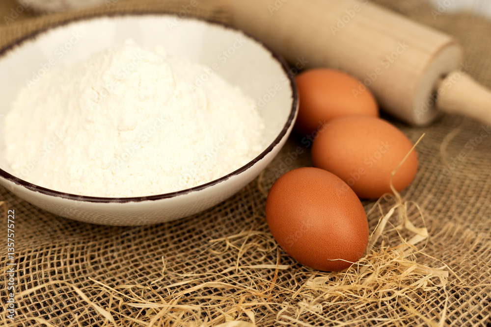 Eggs, flour and rolling pin. Homemade pastries. Dough Ingredients
