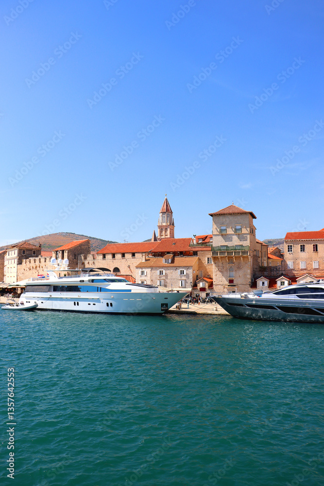 Beautiful old buildings, boats and yachts on the promenade in Trogir, Croatia. Sunny summer day in Trogir.