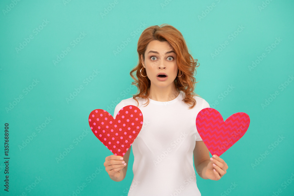 amazed young girl with red heart on blue background amazed young girl with red heart on blue background
