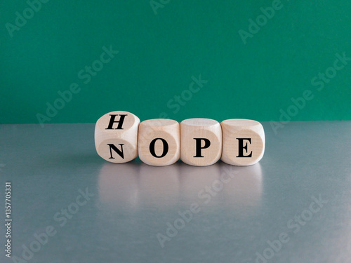 Obraz na płótnie Hope or nope symbol. Turned a wooden cube and changes the word 'nope' to 'hope'. Beautiful green background, gray table. Business and hope or nope concept. w salonie