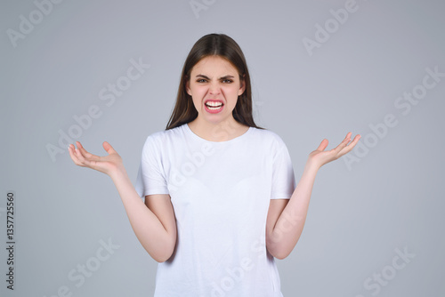 Woman with angry expression. Angry hateful girl furious. Angry rage woman face. Anger woman with furious negative emotion portrait. Aggressive and mad girl bad behavior in studio.