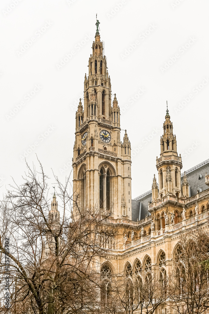 Fototapeta premium A large, white building Vienna City Hall with a clock tower and a spire