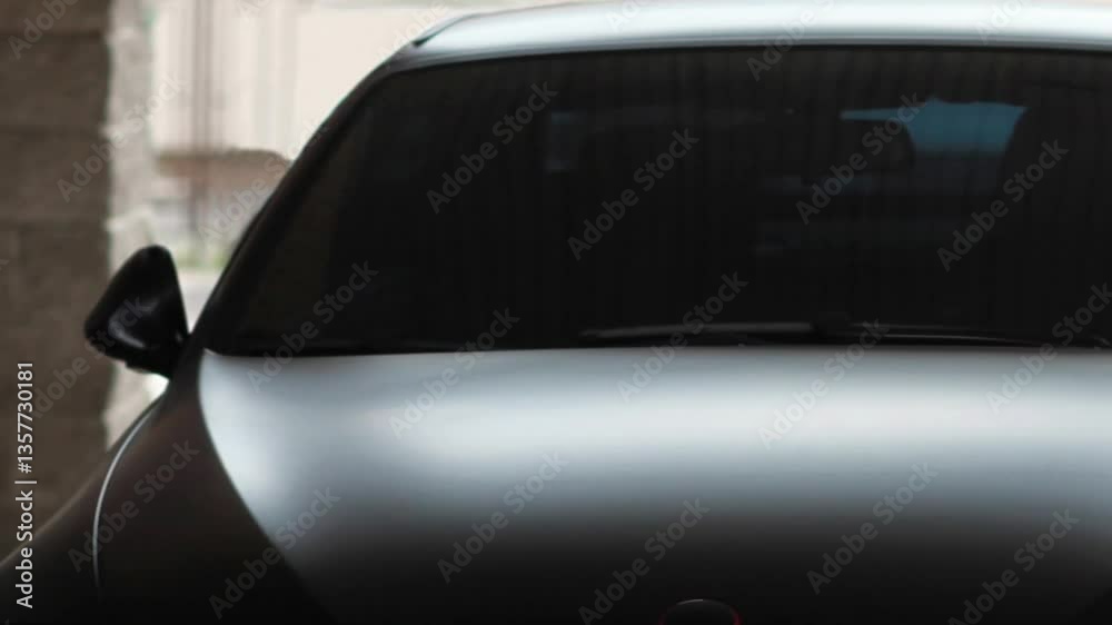 expensive black car, tinted windshield