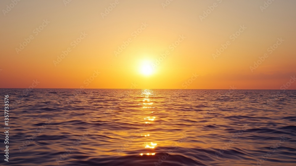 Fototapeta premium A serene sunset casts golden hues over calm ocean waters, creating a tranquil and picturesque scene.
