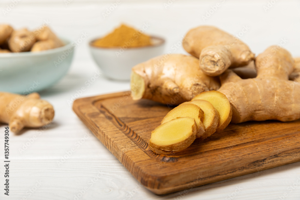 Fototapeta premium Fresh ginger on wooden background. Dry ginger. Sliced ginger with honey and lemon. Ginger root. Traditional alternative medicine, healing tea for immunity. Seasoning and spices concept. Copy space.