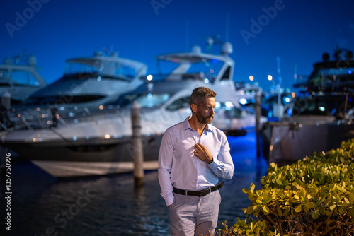 Rich millionaire man near yacht. Wealthy charismatic millionaire business man with luxury lifestyle. Millionaire man on private yacht. Financial freedom. Expensive yacht with millionaire business man.