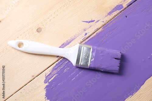 Fototapeta Naklejka Na Ścianę i Meble -  Smear of violet paint and brush on wooden table, top view