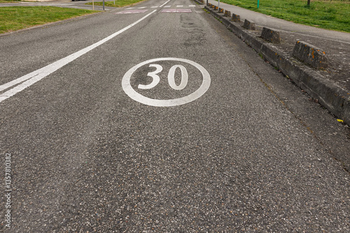 Obraz na płótnie Speed limit sign indicating 30 km/h on a quiet road in a residential area w salonie