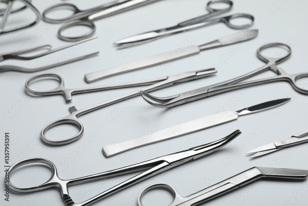 Different surgical tools on light gray background, closeup Different surgical tools on light gray background, closeup