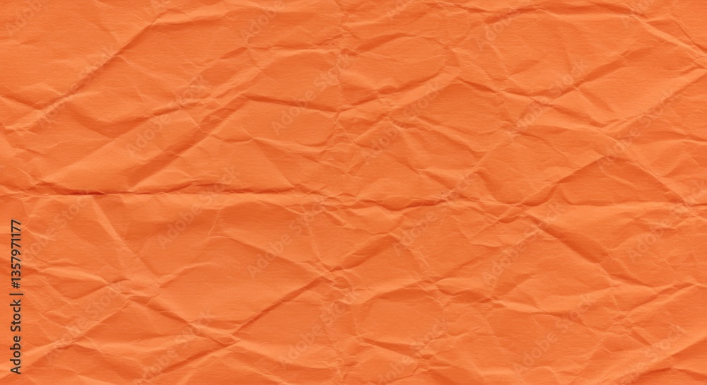 Fototapeta premium A texture of vibrant orange tissue paper crumpled and wrinkled to create random patterns