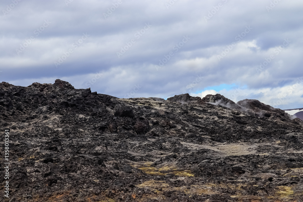Volcanic landscape emitting steam in Iceland near Leirhnjukur mountain Volcanic landscape emitting steam in Iceland near Leirhnjukur mountain