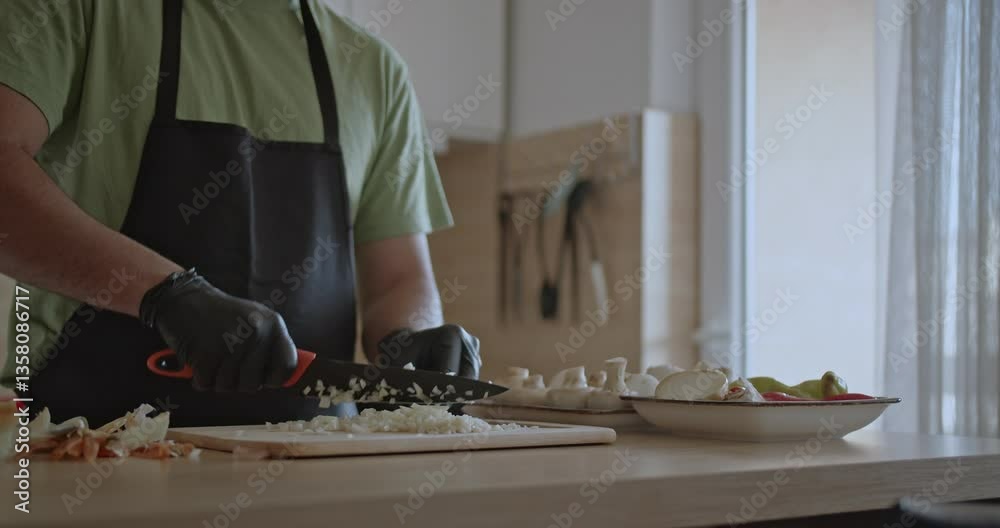custom made wallpaper toronto digitalA man wearing black gloves finely chops onions on a wooden cutting board in preparation for cooking a meal at home.