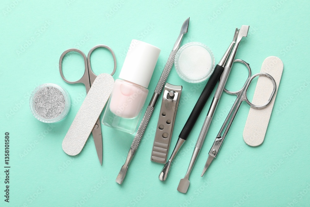 Naklejka premium Set of different manicure tools on turquoise background, flat lay