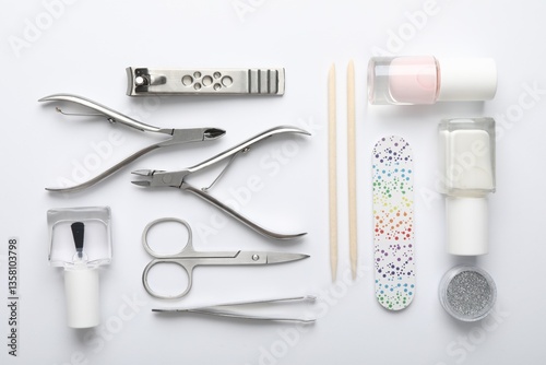 Set of different manicure tools on white background, flat lay