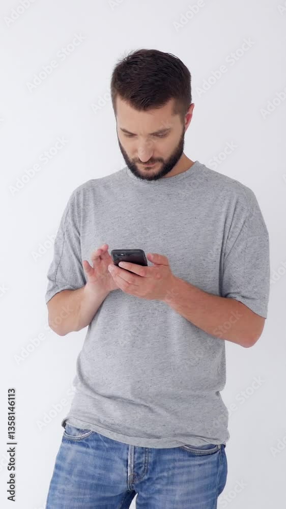 Focused Caucasian middle aged man using phone for online entertainment or internet browsing on white background. Leisure time in cyberspace. Vertical video. Focused Caucasian middle aged man using phone for online entertainment or internet browsing on white background. Leisure time in cyberspace. Vertical video.