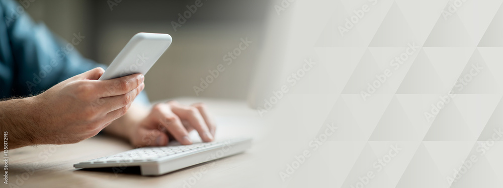 Fototapeta premium Unrecognizable businessman working with smartphone and computer in office, man hands holding mobile phone and typing on pc keyboard, using modern gadgets for business, cropped shot, closeup