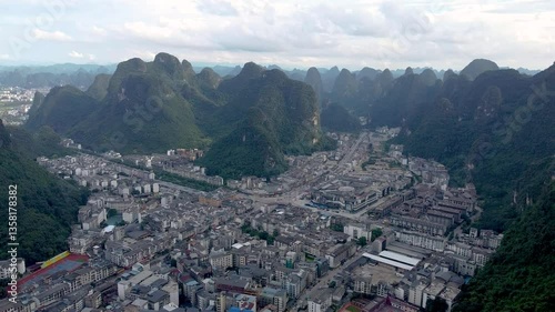 aerial view of the city of Yangshuo surrounded by Guilin mountains and river Li in China
