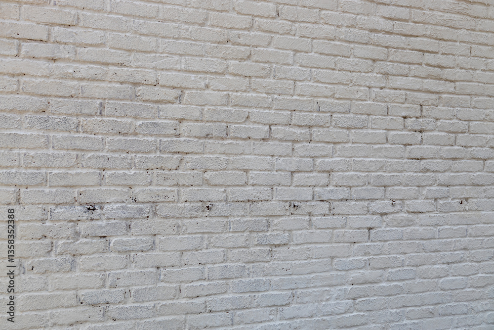 Obraz premium Full frame abstract texture background of a grungy white painted antique brick wall that shows some weathering and peeling paint