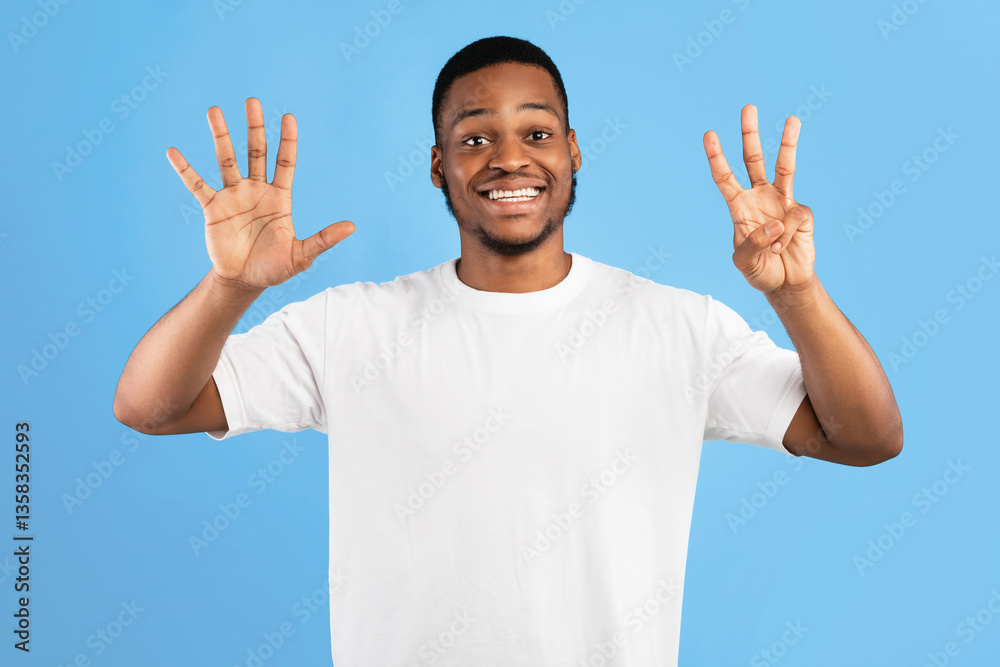 Black Man Showing Number Eight Counting On Fingers Standing Over Blue Background. Studio Shot Black Man Showing Number Eight Counting On Fingers Standing Over Blue Background. Studio Shot