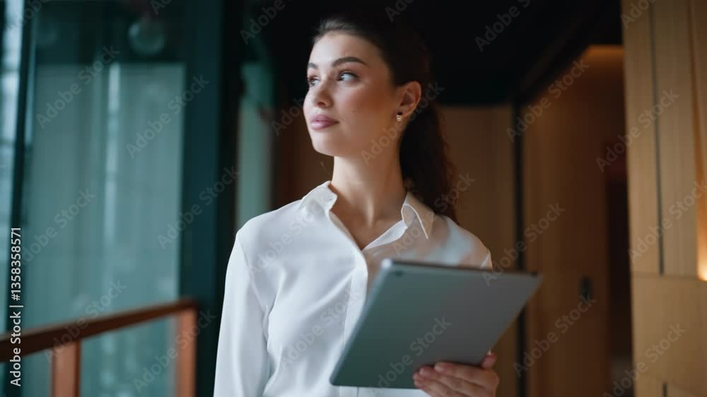 Successful businesswoman walking business center corridor holding tablet closeup